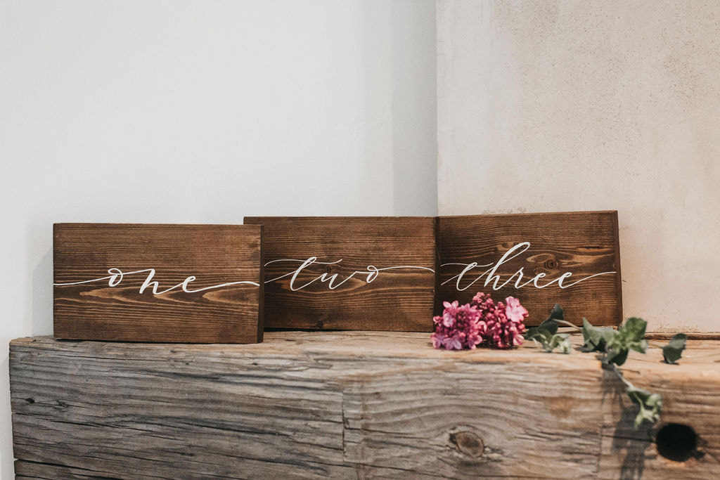 Stained wood with white lettering